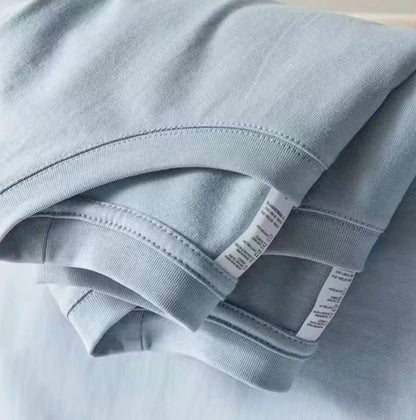 Folded cotton t-shirts showing stitched hem and sleeve detail