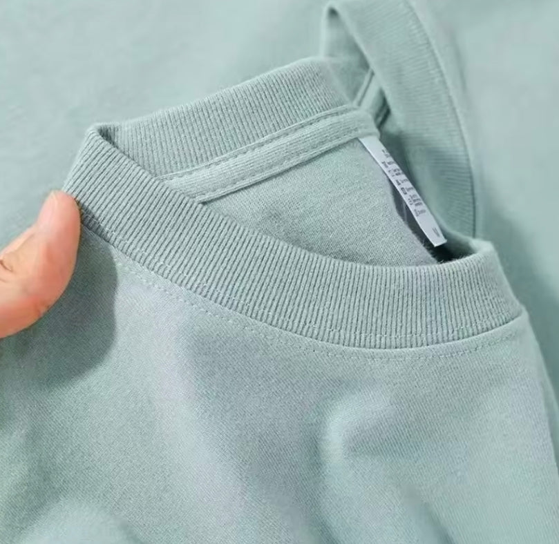 Ribbed O-neck collar detail on a mint cotton t-shirt